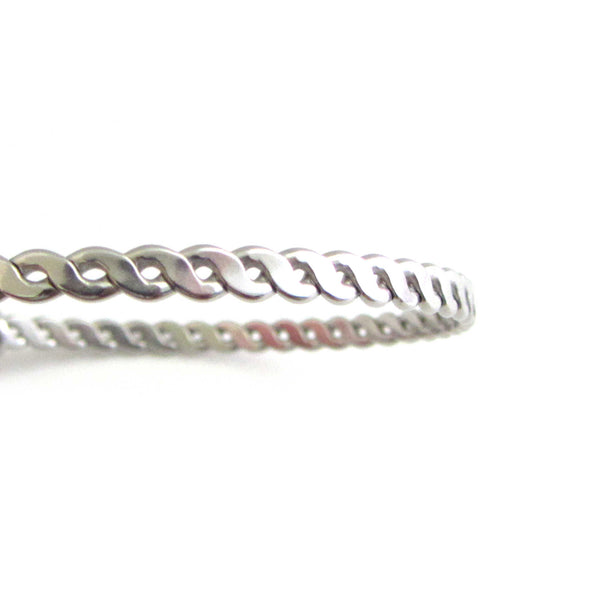 stainless steel bangle close up of braided twist pattern