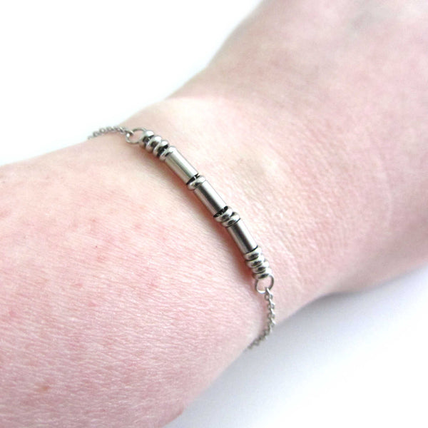 'sarah' stainless steel morse code bracelet worn on wrist for others to read