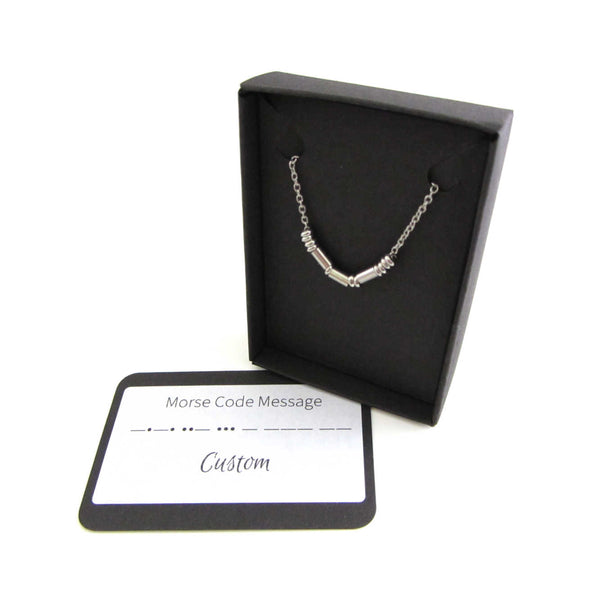 'sarah' name necklace written in morse code stainless steel beads on a stainless steel chain shown in box with custom morse code message card