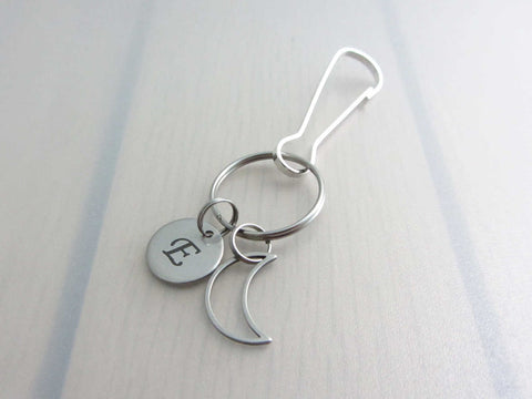 stainless steel laser engraved capital initial letter disc charm and hollow crescent moon charm on a bag charm with snap clip hook
