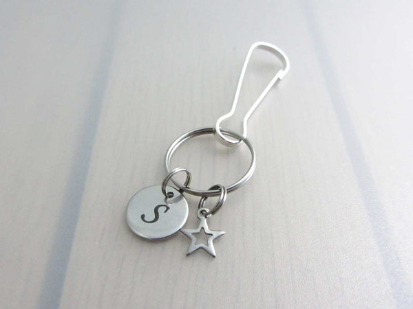 stainless steel laser engraved capital initial letter disc charm and hollow star charm on a bag charm with snap clip hook