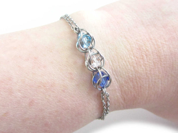 captured light blue, clear and dark blue crystal beads chainmaille bracelet on wrist