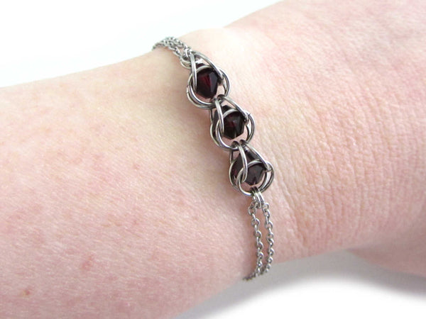 three captured red crystal beads chainmaille bracelet on wrist