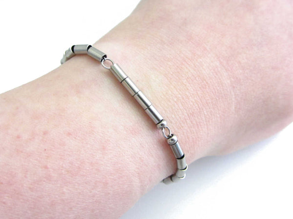 '1 9 10' date stainless steel morse code bracelet worn on wrist for wearer to read