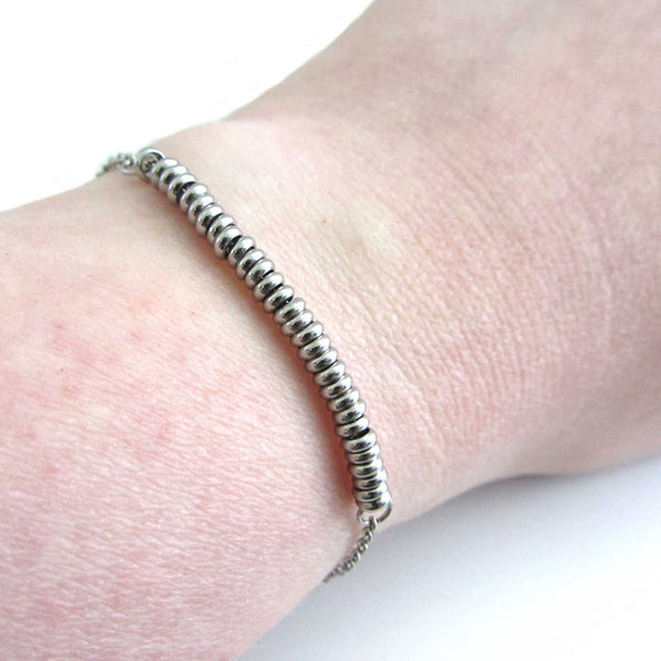 30 stainless steel bead one for each year bracelet on a stainless steel chain shown worn on wrist