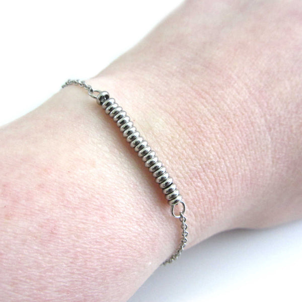 21 stainless steel bead one for each year bracelet on a stainless steel chain shown worn on wrist