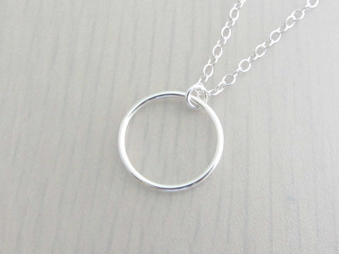 silver circle ring on a silver chain
