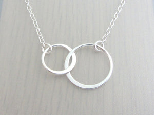 two linked silver circle rings on a silver chain