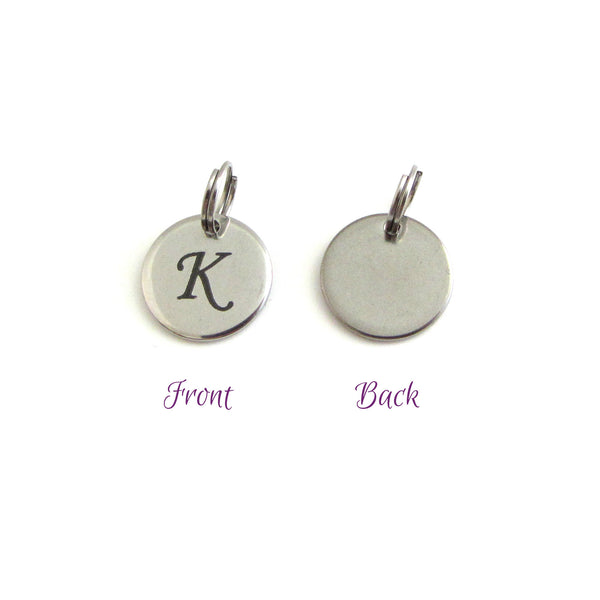 stainless steel disc charm front has letter, back is plain