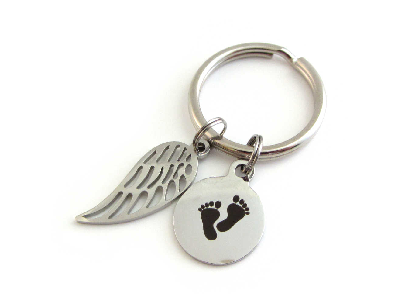 stainless steel single angel wing charm and a laser engraved baby footprints charm on a keyring