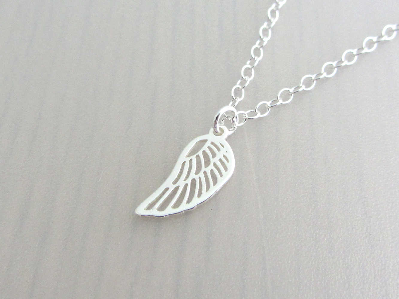 silver single angel wing charm on a silver chain