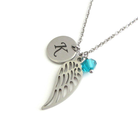 laser engraved capital initial letter disc charm, a single angel wing charm and a blue/green crystal charm on a stainless steel chain