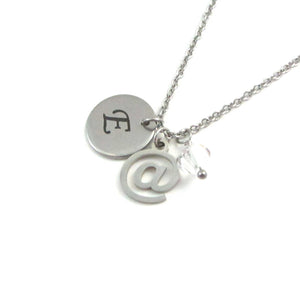 laser engraved capital initial letter disc charm, computer email at symbol sign charm and a clear crystal charm on a stainless steel chain