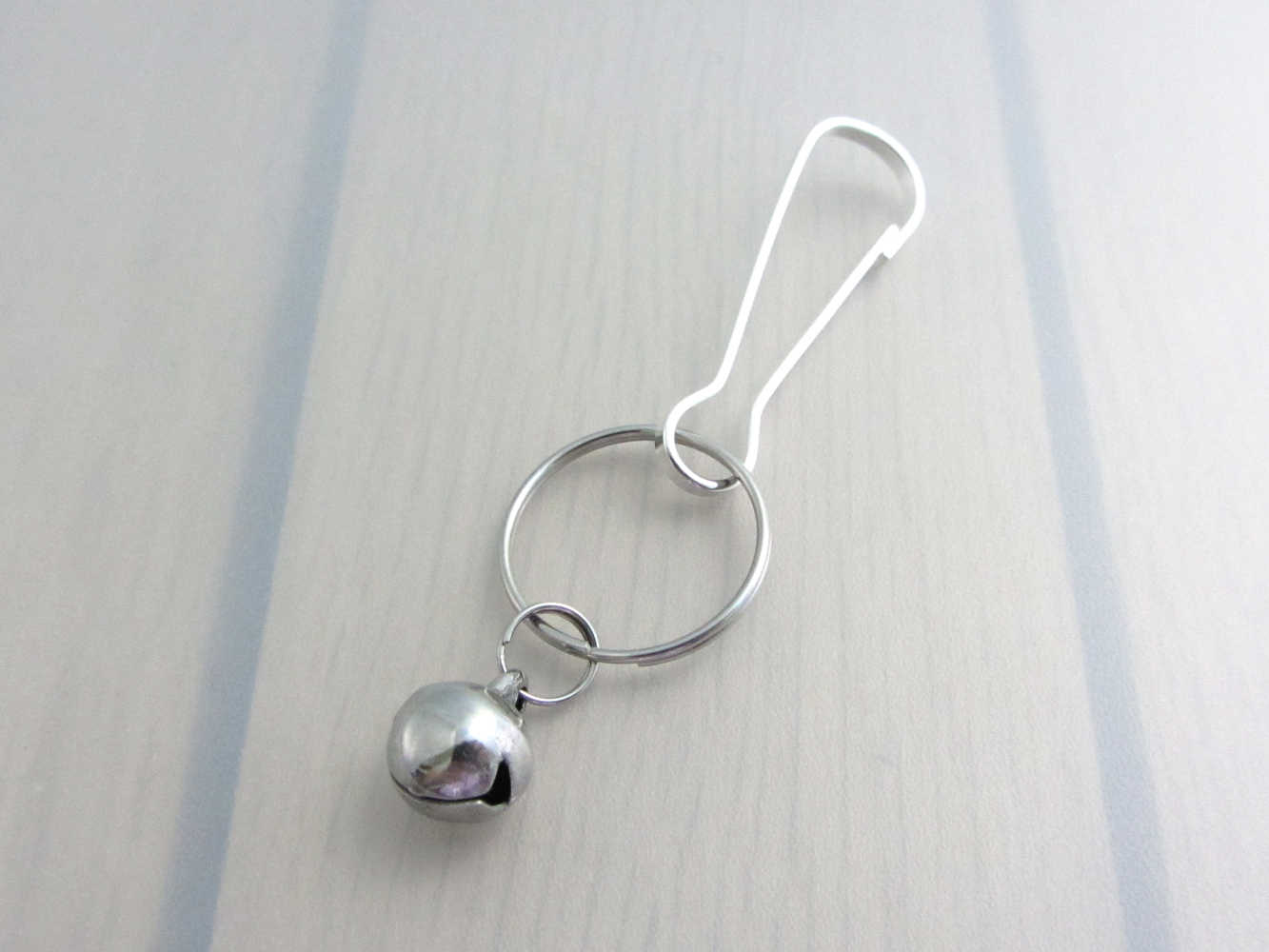 stainless steel bell charm on a bag charm with snap clip hook