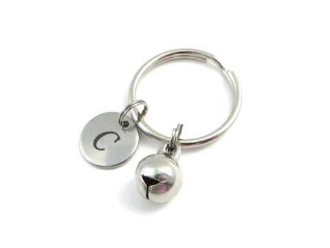 stainless steel laser engraved capital initial letter disc charm and bell charm on a keyring