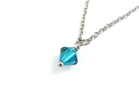 blue-green coloured crsytal charm on a stainless steel chain