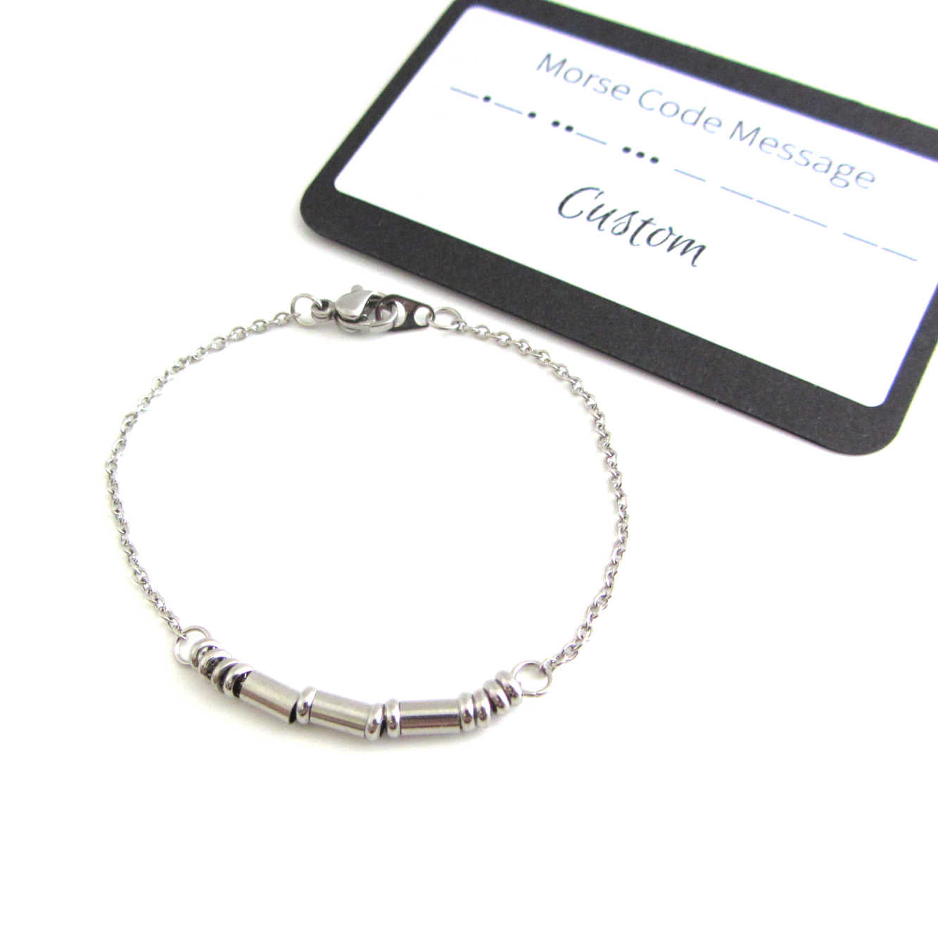 'sarah' name bracelet written in morse code stainless steel beads on a stainless steel chain with custom morse code message card