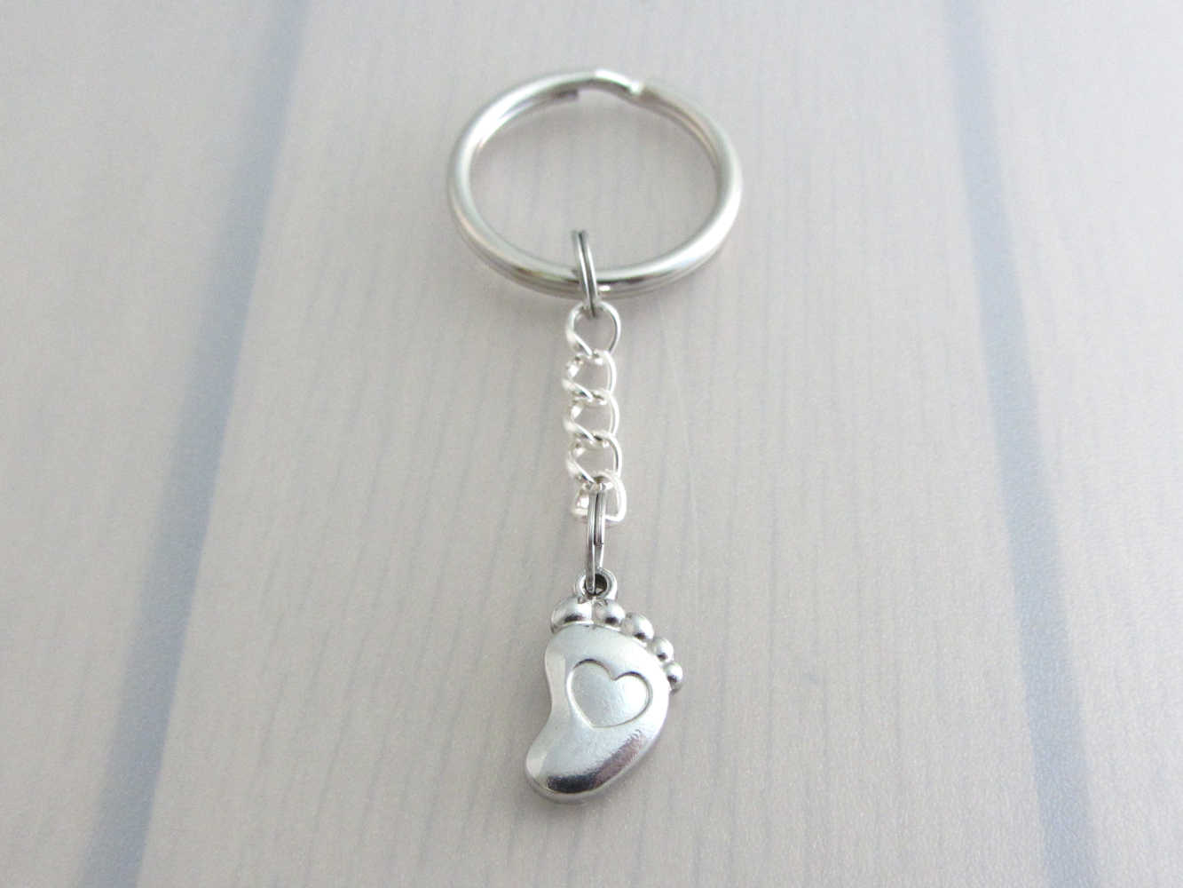 stainless steel single foot charm with indented heart on a chain keyring