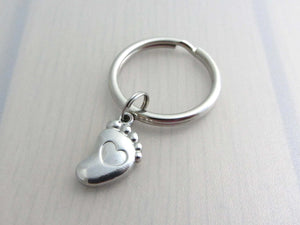 stainless steel single foot charm with indented heart on a keyring
