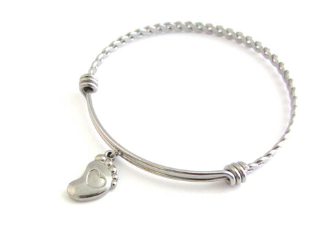 stainless steel single foot charm with indented heart on a bangle with braided twist pattern