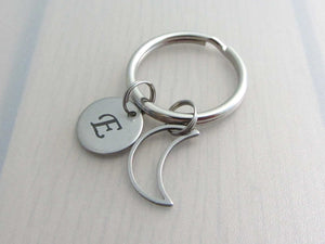 stainless steel laser engraved capital initial letter disc charm and hollow crescent moon charm on a keyring