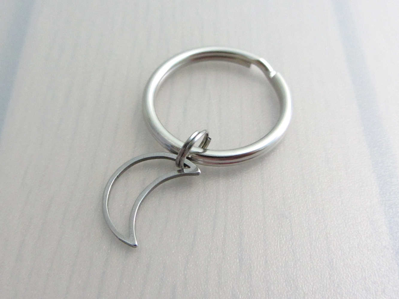 stainless steel hollow crescent moon charm on a keyring