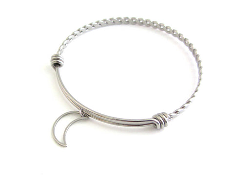 stainless steel hollow crescent moon charm on a bangle with braided twist pattern