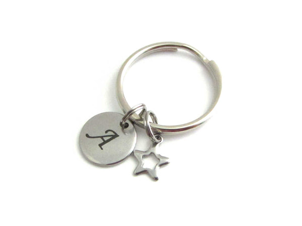 stainless steel laser engraved capital initial letter disc charm and hollow star charm on a keyring