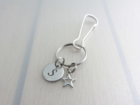 stainless steel laser engraved capital initial letter disc charm and hollow star charm on a bag charm with snap clip hook