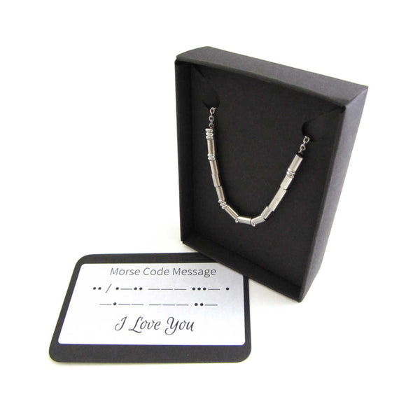 'i love you' necklace written in morse code stainless steel beads on a stainless steel chain shown in box with i love you morse code message card