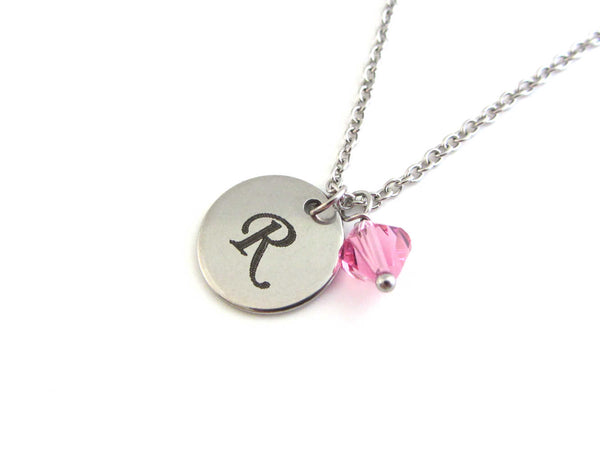 laser engraved capital initial letter disc charm and a pink crystal charm on a stainless steel chain