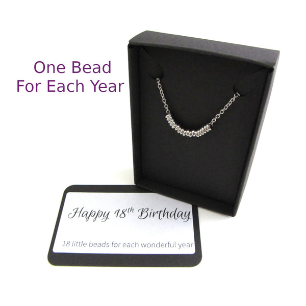 one stainless steel bead for each year necklace on a stainless steel chain shown in black gift box with happy birthday message card