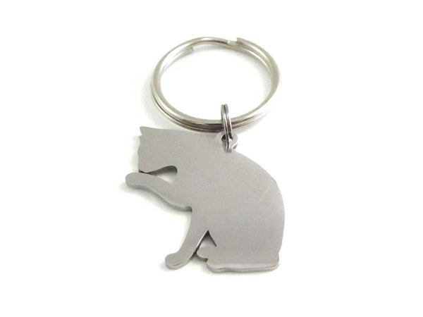 stainless steel pet cat sitting licking paw charm on a keyring