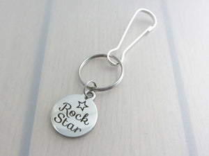 stainless steel laser engraved "rock star" with star charm on a bag charm with snap clip hook