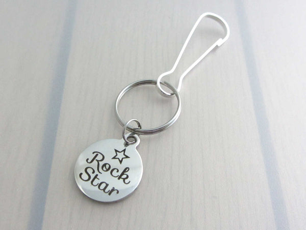 stainless steel laser engraved "rock star" with star charm on a bag charm with snap clip hook