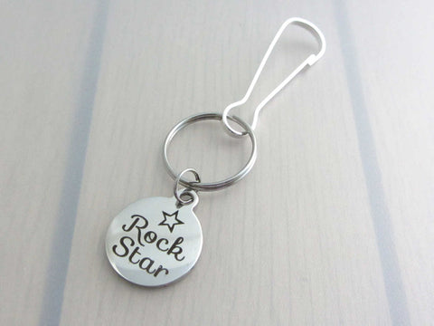 stainless steel laser engraved "rock star" with star charm on a bag charm with snap clip hook
