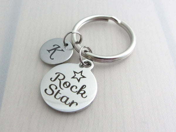 stainless steel laser engraved capital initial letter disc charm and laser engraved "rock star" with star charm on a keyring