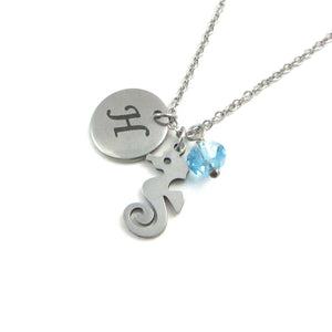 laser engraved capital initial letter disc charm, nautical seahorse charm and a light blue crystal charm on a stainless steel chain