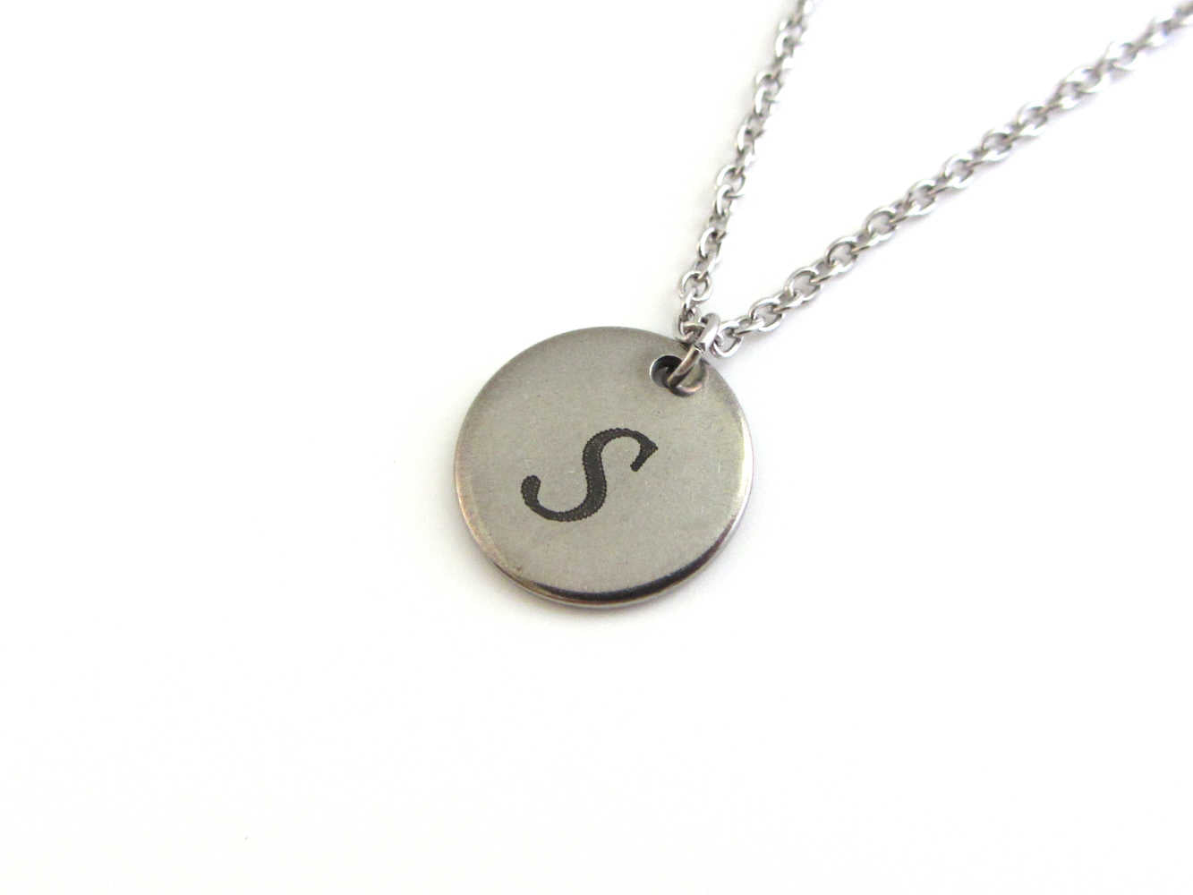 laser engraved capital initial letter disc charm on a stainless steel chain