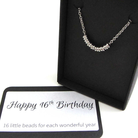 16 stainless steel beads one for each year necklace on a stainless steel chain shown in black gift box with happy 16th birthday message card