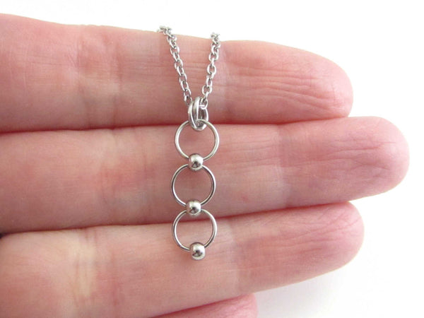 beaded linked circle rings chainmaille pendant on a stainless steel chain