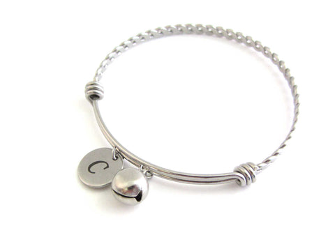 stainless steel laser engraved capital initial letter disc charm and bell charm on a bangle with braided twist pattern
