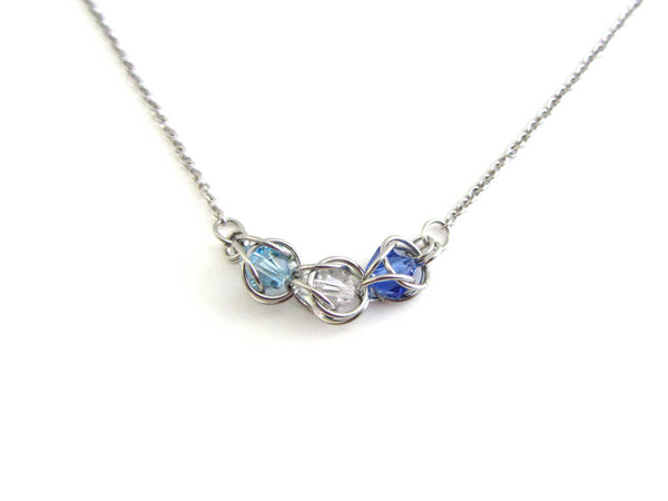 catpured light blue, clear and dark blue crystal beads chainmaille section on a stainless steel chain