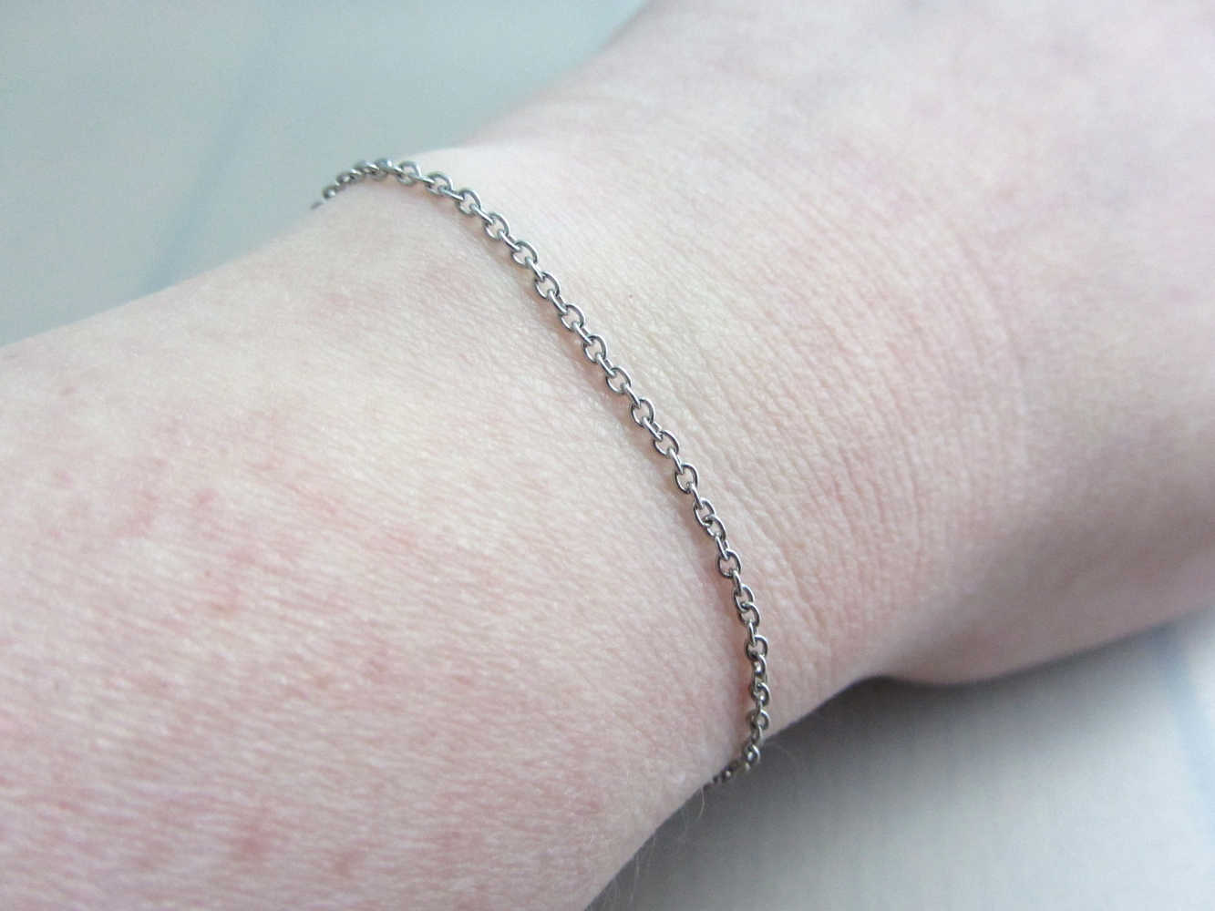 dainty stainless steel chain bracelet on wrist