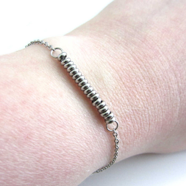18 stainless steel bead one for each year bracelet on a stainless steel chain shown worn on wrist
