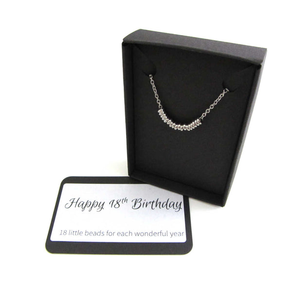 18 stainless steel beads one for each year necklace on a stainless steel chain shown in black gift box with happy 18th birthday message card