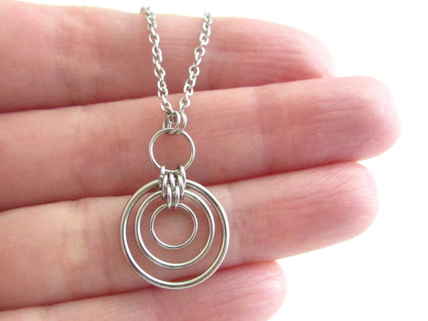 floating linked circle rings chainmaille pendant on a stainless steel chain