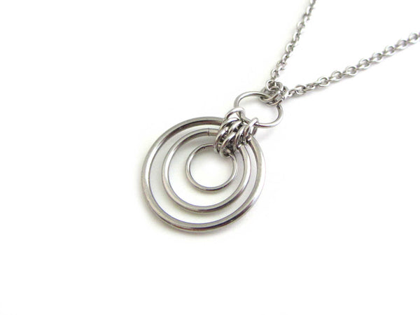 floating linked circle rings chainmaille pendant on a stainless steel chain