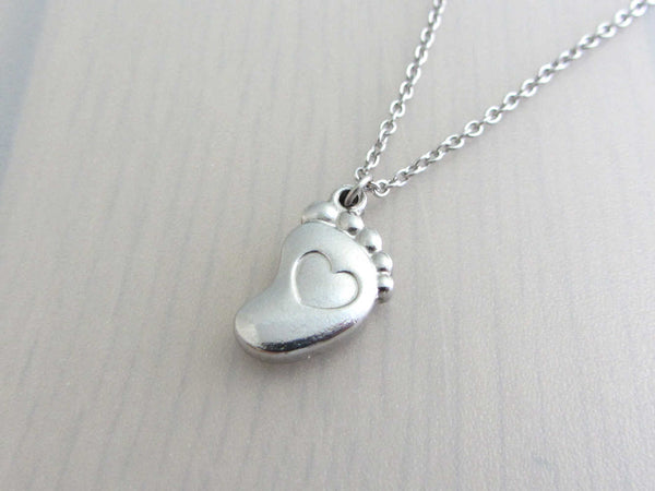 single foot charm with indented heart on a stainless steel chain