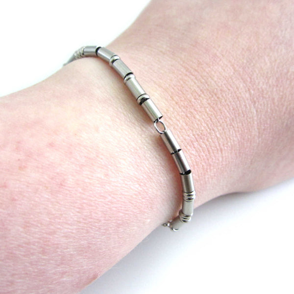 'fuck off' stainless steel morse code bracelet worn on wrist for others to read